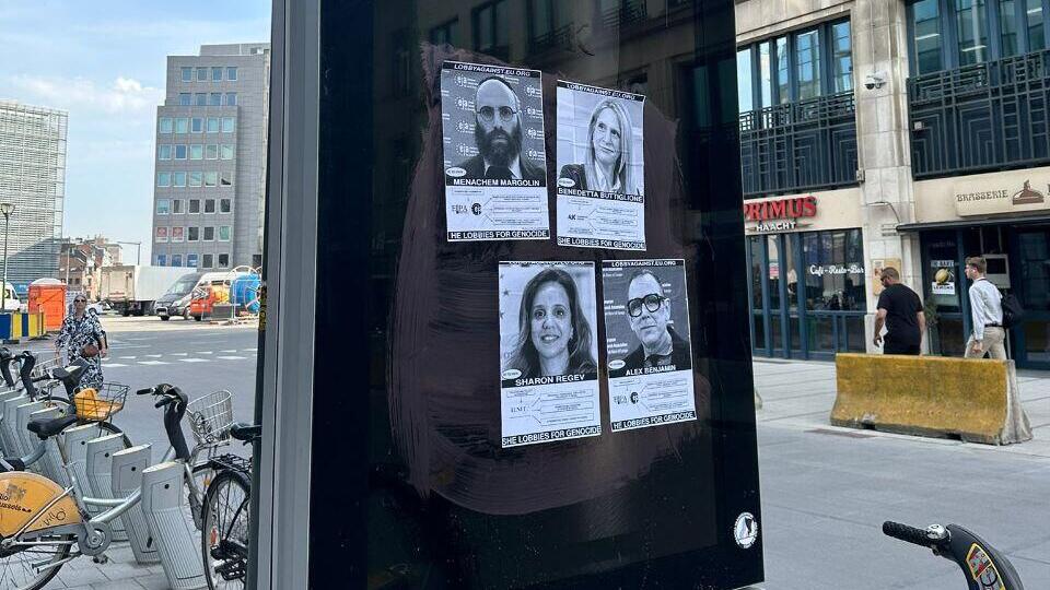 Posters accusing Jewish leaders of being “genocide lobbyists” were hung throughout Brussels (Photo: EJA) פניהם של אנשי איגוד הארגונים היהודיים באירופה בכרזות פרו-פלסטיניות בבריסל