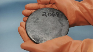 The last element on the periodic table, found naturally in large quantities — and more importantly, a fissile one. A disc of enriched metallic uranium 