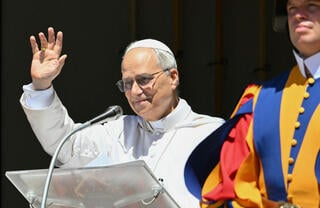 Pope Leo XIV waves the crowd before leading  the Angelus prayer in Rome on Sunday 