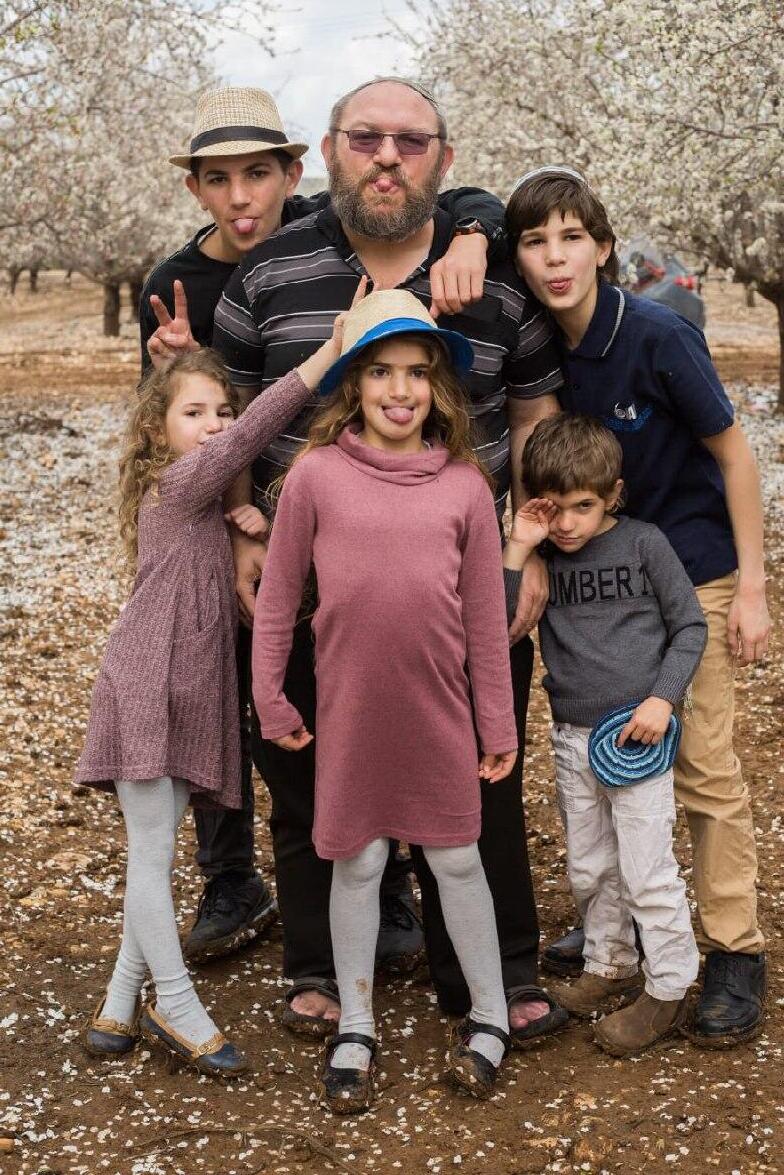 The Galim children with their father, Chaim (Photo: Courtesy of the family) משפחת גלים
