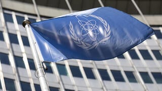In this June 7, 2021, file photo, the flag of the International Atomic Energy Agency (IAEA) waves at the entrance of the Vienna International Center in Vienna 