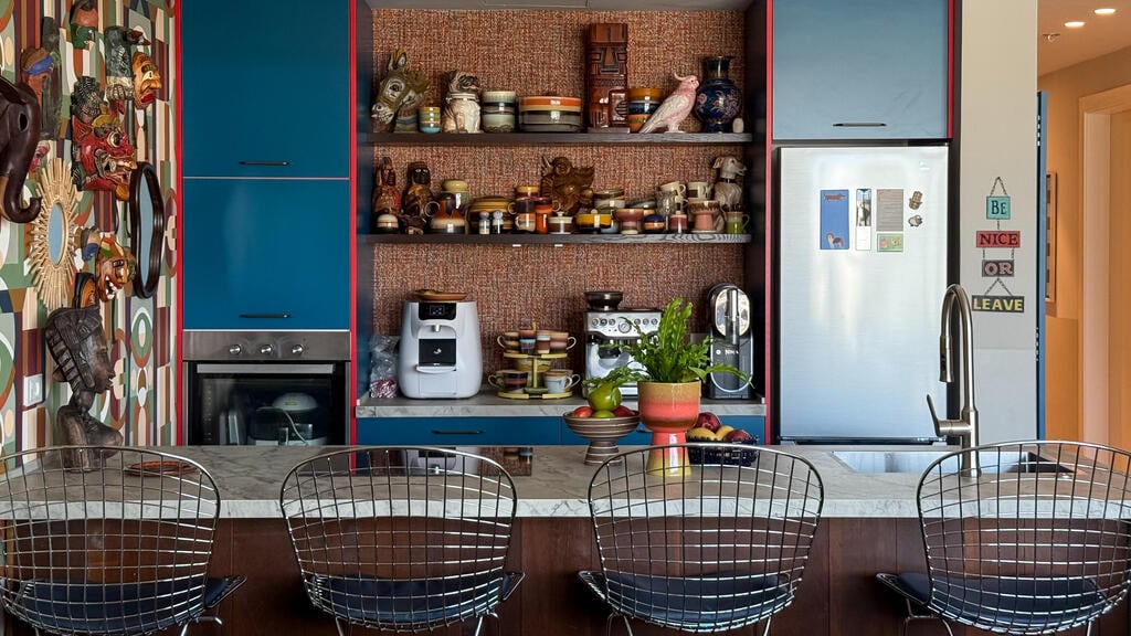 Shelves with dishes and a wall of masks bought in Seoul (Photo: Noam ron) הדירה של דנה ואורי ריץ, תל אביב