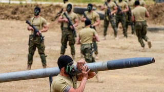 Hezbollah terrorist carrying a rocket 