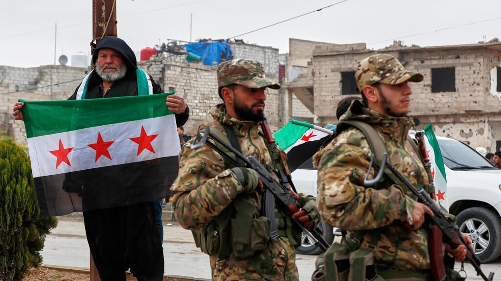 Forces of Syria’s new regime in the suburbs of Damascus (Photo: AP Photo/Omar Sanadiki) סוריה חגיגות שנה ל הפיכה ולהפלת משטר אסד פרברי דמשק לפני מצעד צבאי
