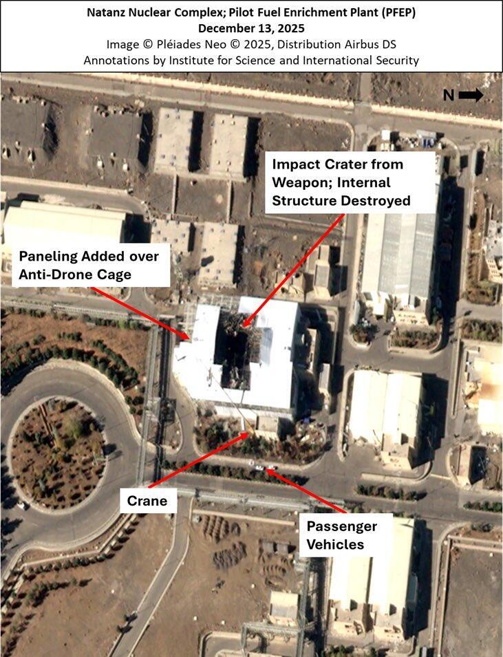 This annotated satellite image taken Dec. 13, 2025, shows damage at Iran’s Natanz nuclear complex, including the Pilot Fuel Enrichment Plant, following June's joint US-Israeli attacks. The image highlights a weapon impact crater, a destroyed internal structure, new paneling placed over an anti-drone cage and nearby vehicles and a crane חידוש הפעילות האיראנית בנתנז