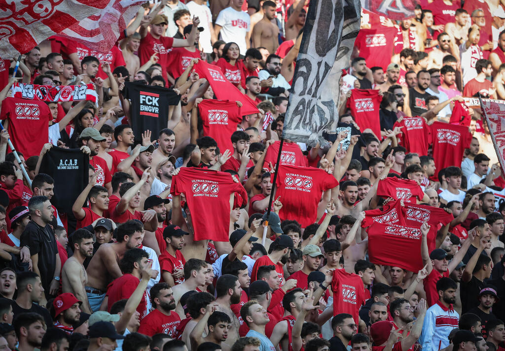 אוהדי הפועל ת"א מוחים נגד המשטרה (צילום: עוז מועלם) אוהדי הפועל ת"א חולצה משטרה