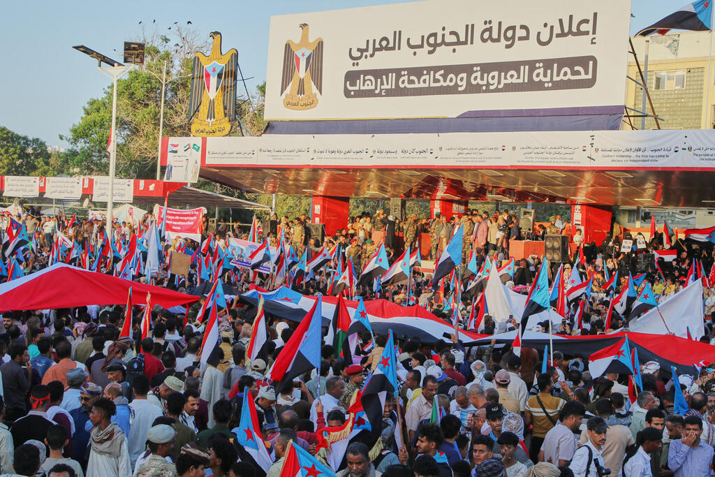 Supporters of the Southern Transitional Council (STC), a coalition of separatist groups seeking to restore the state of South Yemen, hold South Yemen flags during a rally, in Aden, Yemen, Dec. 25, 2025. Arabic reads, 'announcement of South Arab state' 