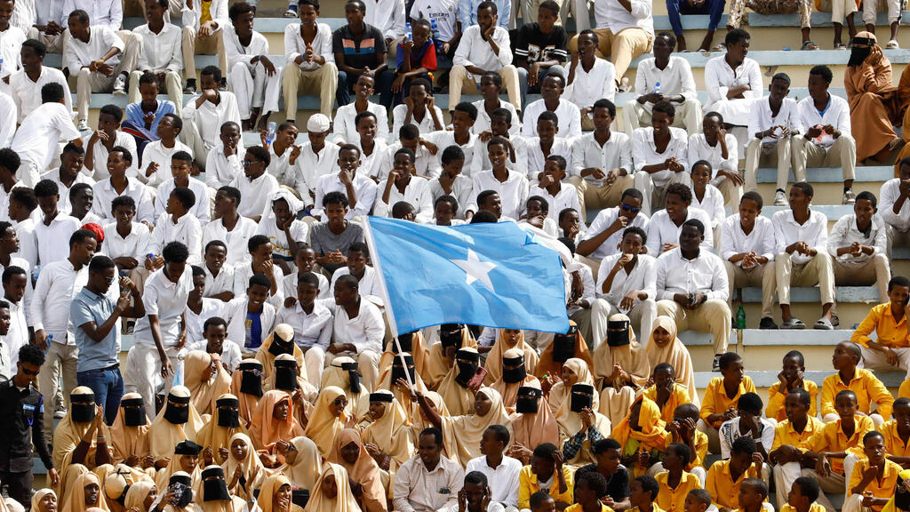 A student waves Somali national flag during a demonstration against Israel's recognition of Somaliland as an independent and sovereign state at the Mogadishu Stadium in Warta Nabada district of Mogadishu on Tuesday