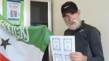 Chabad emissary Yanki Rubin with a copy of the Tanya in Somaliland שליח חב"ד ינקי רובין עם ספר התניא בסומלילנד