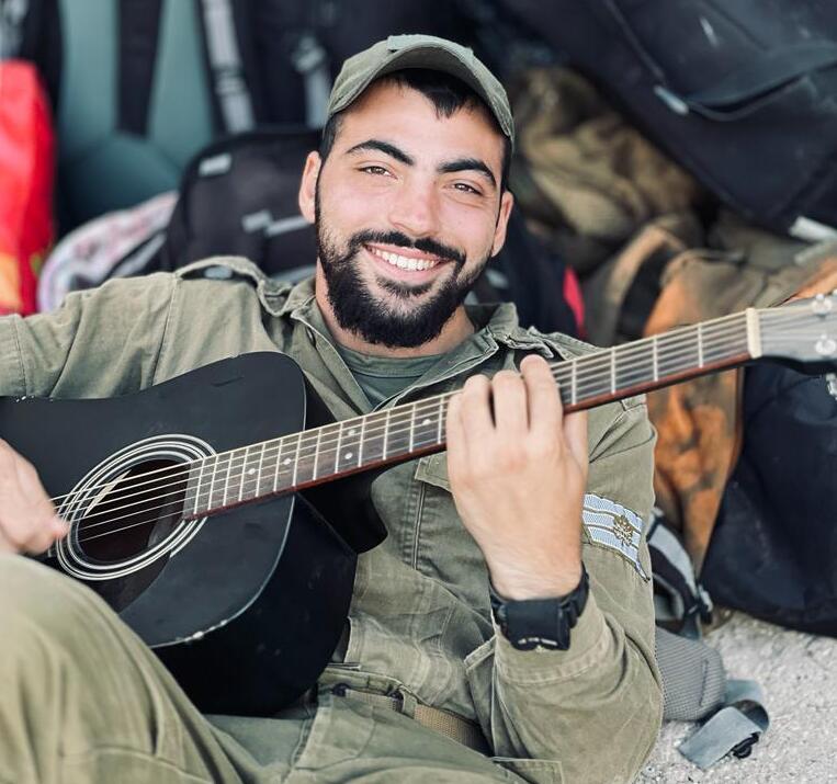 Amichai Oster enjoyed playing guitar for his fellow soldiers (Photo: Courtesy) Amichai Oster enjoyed playing guitar for his fellow soldiers