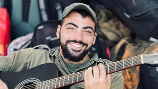 Amichai Oster enjoyed playing guitar for his fellow soldiers 