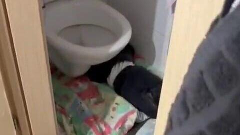 An infant sleeping under a toilet seat תיעוד מתוך הגן בירושלים