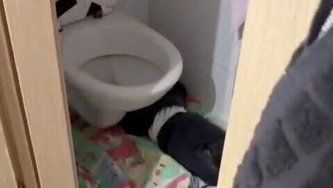 An infant sleeping under a toilet seat תיעוד מתוך הגן בירושלים