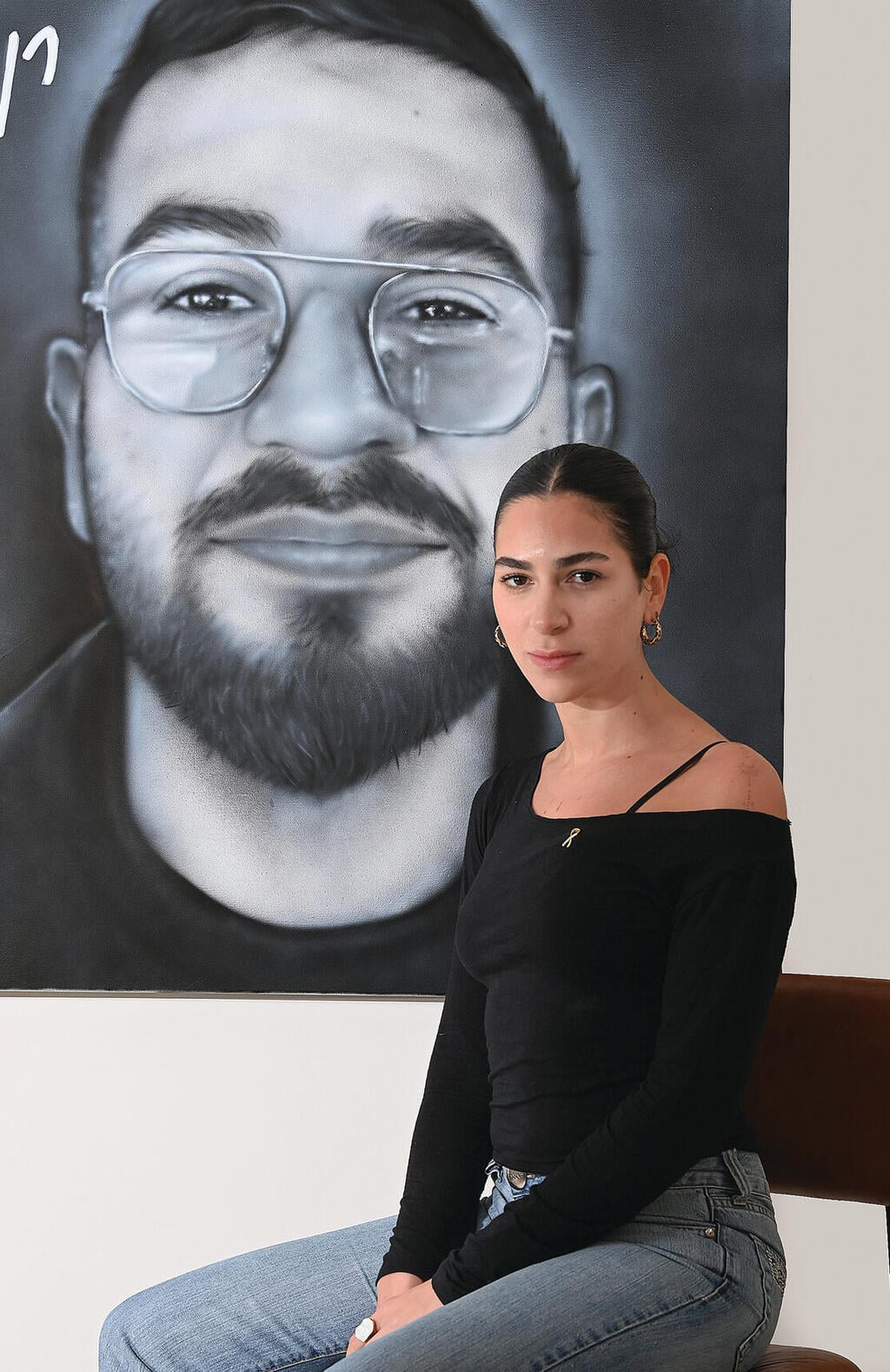 שירה גואילי על רקע דיוקנו של רן, השבוע. "המאבק זה הג'וב 'הנחשק' שלי והוא בחר אותי. אני מקווה שרני גאה בי" (צילום: הרצל יוסף) שירה גואילי על רקע דיוקנו של רן, השבוע. "המאבק זה הג'וב 'הנחשק' שלי והוא בחר אותי. אני מקווה שרני גאה בי" | צילום: הרצל יוסף