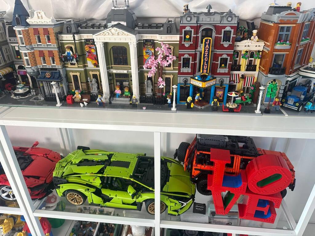 Modular LEGO buildings, including a jazz club and museum, line the upper shelf in Hen Amar’s curated display, with Technic sports cars and custom 'LOVE' sculpture below (Photo: Bar Gindy) Modular LEGO buildings, including a jazz club and museum, line the upper shelf in Chen Amar’s curated display, with Technic sports cars and custom 'LOVE' sculpture below