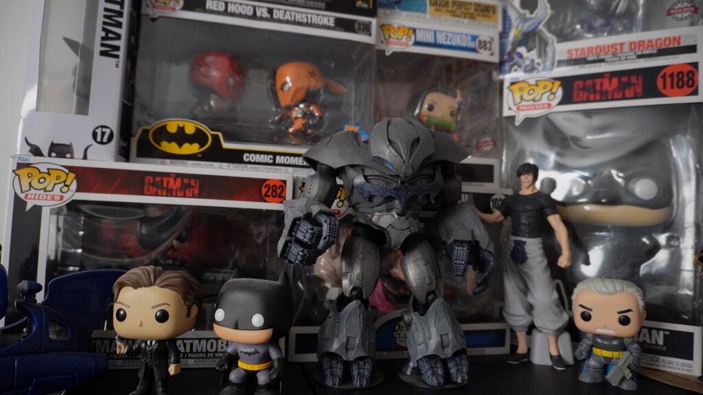 A selection of Pop! vinyl figures from Yarin’s collection, including Batman variants, anime characters and pop culture icons, displayed floor to ceiling in his room 