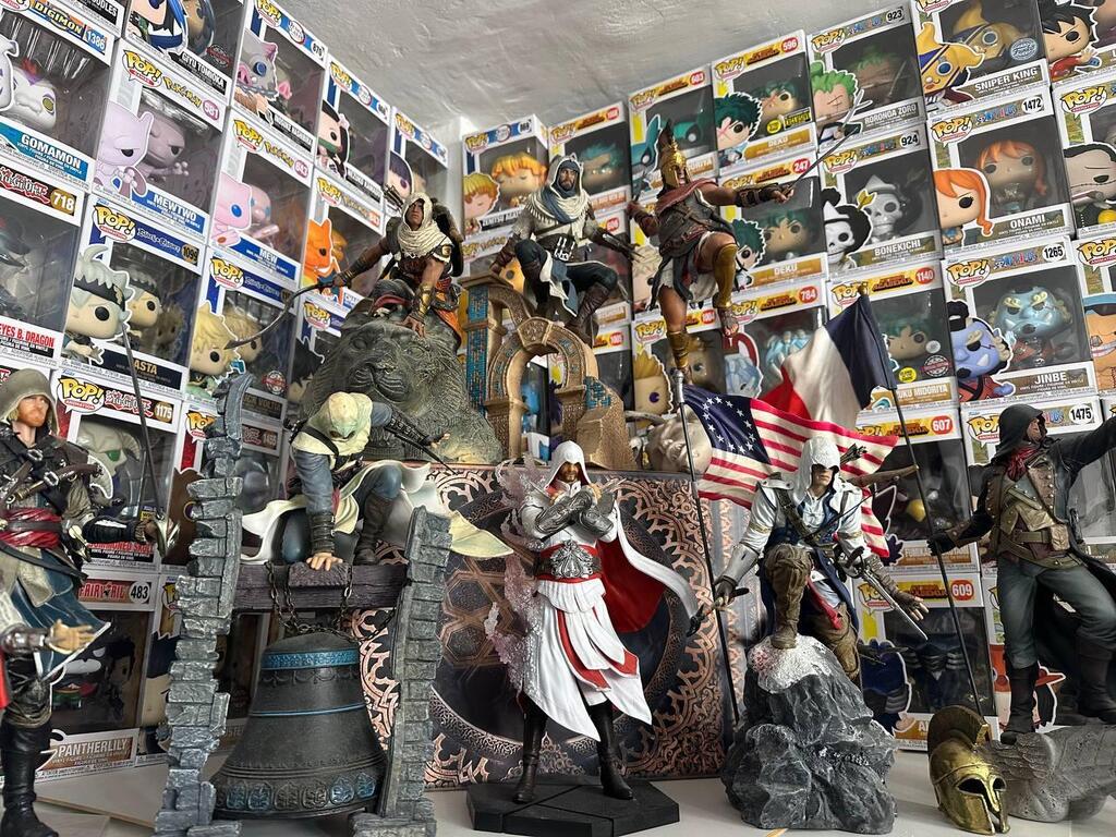 Statues from the Assassin’s Creed franchise form a dramatic centerpiece in Yarin’s collection, surrounded by dozens of Pop! figures 