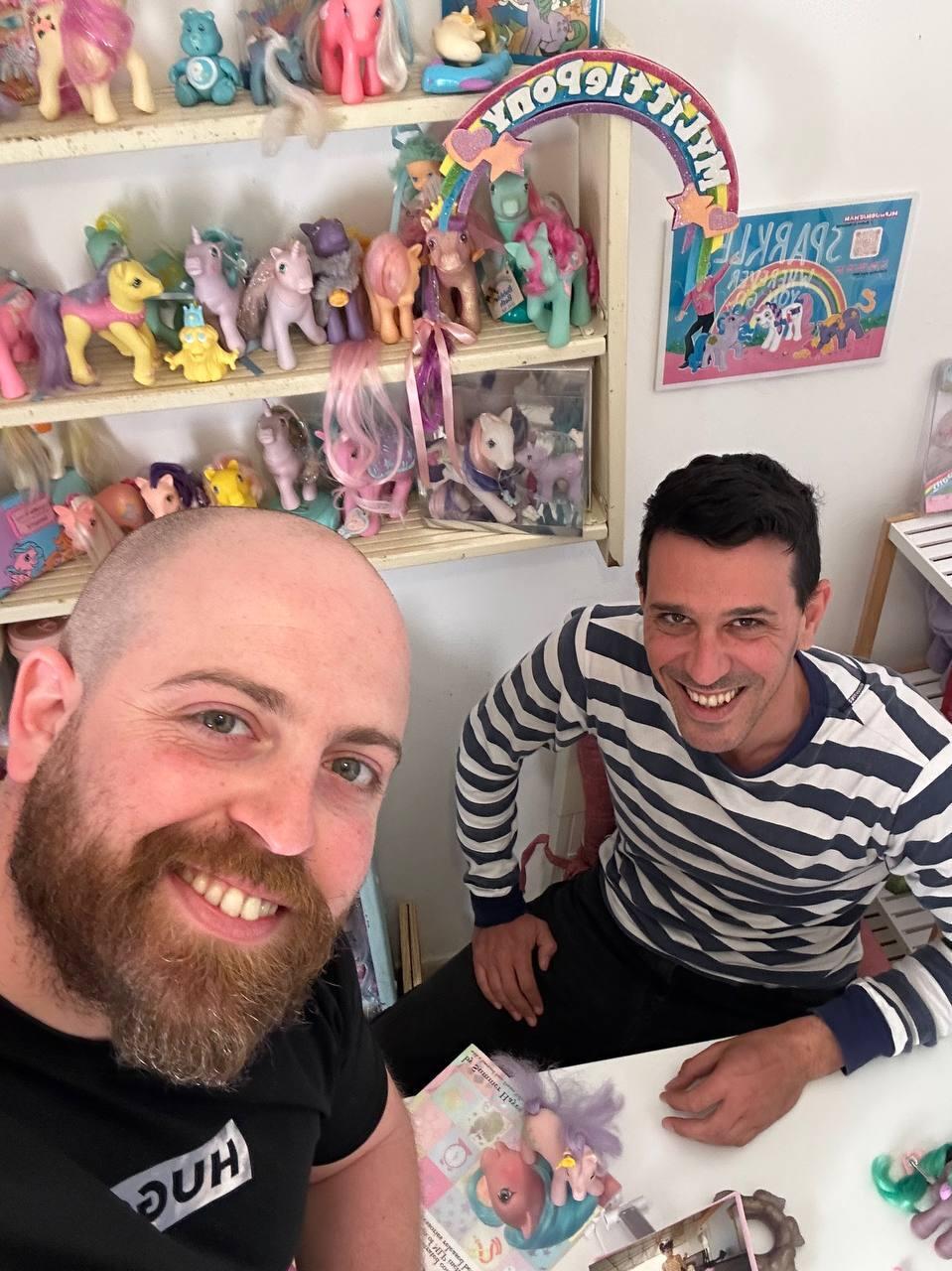Jonathan (right) poses with Bar Gindi (left), host of the People and Collectors podcast, beside part of the extensive My Little Pony collection (Photo: Courtesy) Jonathan (right) poses with Bar Gindi (left), host of the People and Collectors podcast, beside part of the extensive My Little Pony collection