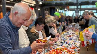 Volunteers with Sword of Iron Israel Volunteer Corp packing goods