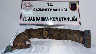 כתב היד העברי החקוק באותיות זהב על עור פיתון, מוצג לצד מעטפת הנחושת המעוטרת שלו