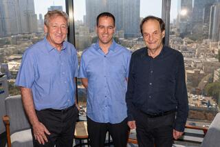 Former government minister Dan Meridor, right, and Professor Amitai Ziv, left, members of the award committee, with 2026 Charles Bronfman Prize winner Tomer Malchi 