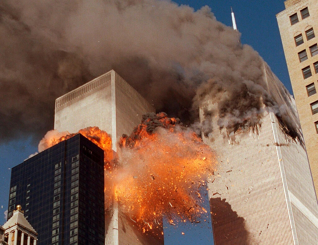 An explosion erupts from the World Trade Center after the second plane strikes the South Tower in New York on Sept. 11, 2001 (Photo: AP Photo/Chao Soi Cheong, File) אסון התאומים הפיגוע במגדלי התאומים 11 בספטמבר 2001