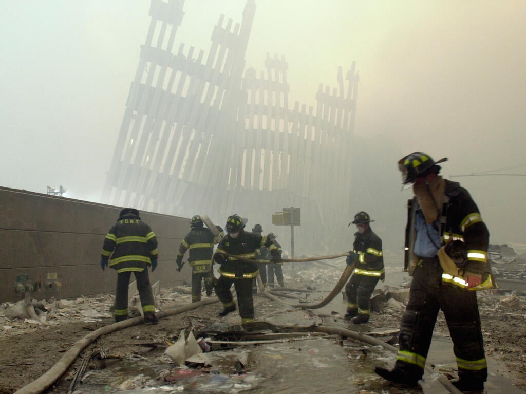 New York City firefighters work amid the rubble of the World Trade Center following the Sept. 11, 2001, terrorist attacks (Photo: AP Photo/Mark Lennihan, File) אסון התאומים הפיגוע במגדלי התאומים 11 בספטמבר 2001